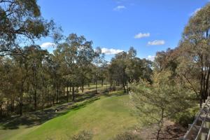 a view of a golf course with trees in the background at Villa 1br Merlot Villa located within Cypress Lakes Resort in Pokolbin +8 photos
