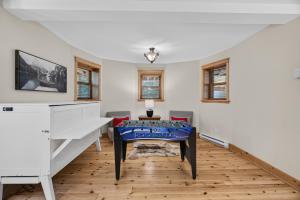a living room with a table and chairs at Fiddler Lake Resort - Deer 30 in Mille-Isles +23 photos