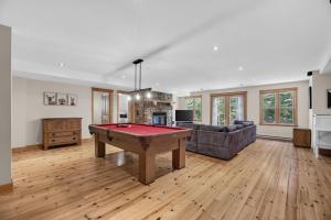 a living room with a pool table and a couch at Fiddler Lake Resort - Deer 30 in Mille-Isles
