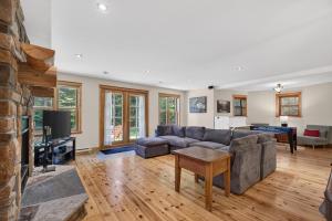 a living room with a couch and a fireplace at Fiddler Lake Resort - Deer 30 in Mille-Isles