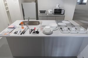 a kitchen counter with dishes and utensils on it at MN Building - Vacation STAY 11196 in Nagoya +17 photos