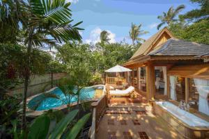 a house with a deck with a swimming pool at Santhiya Koh Phangan Resort & Spa - Up to THB 2,000 Resort Credit per Night in Thong Nai Pan Noi