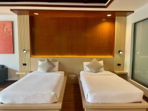 two beds sitting next to each other in a room at Ramada by Wyndham Aonang Krabi in Ao Nang Beach