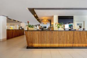 a lobby with a counter and a restaurant at SOL by Meliá Palmanova Mallorca in Palmanova