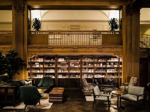 a library with couches and chairs and bookshelves at Fairmont Olympic Hotel in Seattle