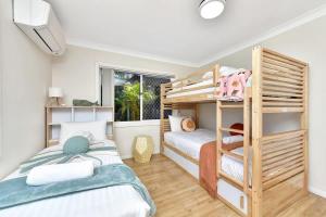 a bedroom with two bunk beds and a window at Upper Deck On Dobell in Wangi Wangi +25 photos