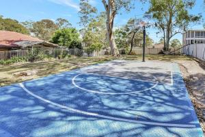 a basketball court in a yard with a basketball hoop at Upper Deck On Dobell in Wangi Wangi