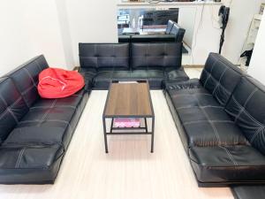 a living room with black leather couches and a coffee table at ISU BASE - Vacation STAY 12851 in Shima