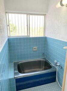 a sink in a blue tiled bathroom with a window at ISU BASE - Vacation STAY 12851 in Shima +42 photos