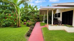 a red path in front of a house at Rio Celeste Birds Garden Apartments with air conditioning and Wifi Starlink in Upala