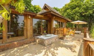 a patio with a hot tub on a house at Santhiya Koh Phangan Resort & Spa - Up to THB 2,000 Resort Credit per Night in Thong Nai Pan Noi