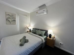 a bedroom with a bed with a pillow on it at NatureWalkBrookfield in Melton South