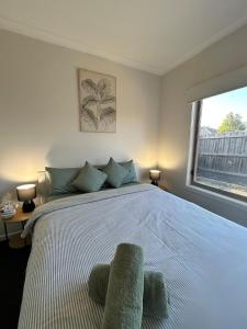 a bedroom with a large bed with a large window at NatureWalkBrookfield in Melton South