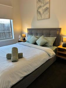 a bedroom with a bed with two pillows on it at NatureWalkBrookfield in Melton South