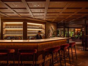 a bar in a restaurant with red stools at UNWIND HOTEL & BAR Okunikko in Nikko