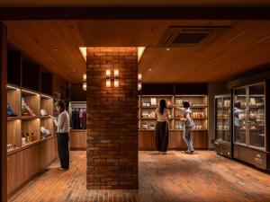 a group of people standing in a room with a brick pillar at UNWIND HOTEL & BAR Okunikko in Nikko +38 photos