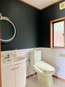 a bathroom with a toilet and a sink and a mirror at Shell Beach Hamanako - Vacation STAY 14730 in Hamamatsu +18 photos
