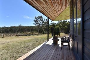 a wooden porch with a bench on a house at The Parsons Retreat in Rothbury