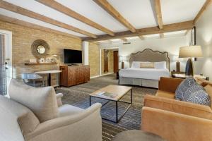 a hotel room with a bed and a tv at Omni La Mansion del Rio in San Antonio