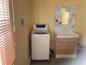 a bathroom with a sink and a fax machine at Formosa Hakodate - Vacation STAY 17455 in Hokuto