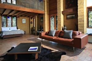 a living room with a couch and a bed at Corymbia Cottage Brokes Secluded Escape for max 4 in Broke