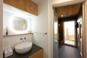 a bathroom with a sink and a mirror at Obaranchi - Vacation STAY 18154 in Kawasaki +22 photos
