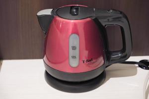 a red tea kettle sitting on top of a counter at R Hotel - Vacation STAY 19199 in Chiba