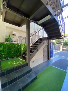 a building with a staircase and green flooring at Frontier First Building - Vacation STAY 19759 in Kagoshima