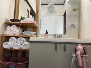 a bathroom with a sink and a mirror and towels at Kohaku - Vacation STAY 20481 in Nagahama +38 photos