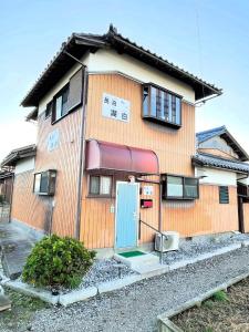 a building with a blue door in front of it at Kohaku - Vacation STAY 20481 in Nagahama