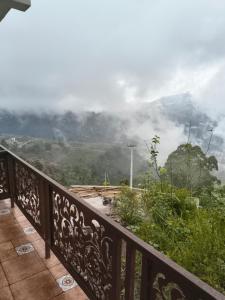 a balcony with a view of a mountain at Kodai Cloud Villa in Kodaikānāl