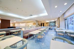 a dining room with tables and chairs in a restaurant at Hotel Hokke Club Hakodate in Hakodate
