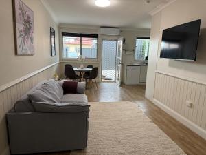 a living room with a couch and a table at Fitzroy Cottage one bedroom CBD accommodation in Tamworth