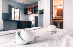 two towels sitting on a bed in a room at Dumaguete Dive Center in Mojon