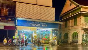 a group of motorcycles parked in front of aarma inn at Tapae Inn in Chiang Mai