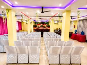a row of white chairs in a banquet hall at hotel wisdom celebration in Motīhāri