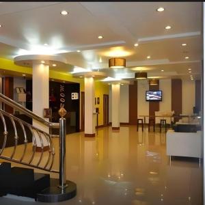 a lobby with chairs and a table in a building at The Room Hotel in Ban Nong Puk