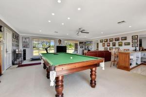 a living room with a pool table in it at Noble Willow Estate in Lovedale