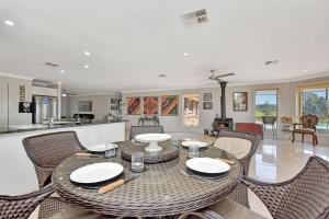 a dining room with a table and chairs at Noble Willow Estate in Lovedale
