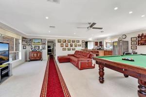 a living room with a pool table and a couch at Noble Willow Homestead in Lovedale