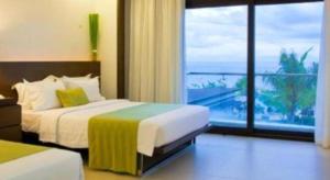 a bedroom with a bed with a view of the ocean at Ciriaco Hotel in Rauis +44 photos