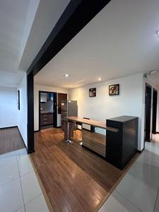 a living room with a table and a refrigerator at Likas Square - KK Apartment Suite in Kota Kinabalu