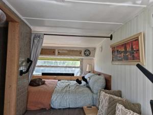 a bedroom in a trailer with a bed and a window at Far View - Pets, Linen, Wi-Fi, Netflix, Caravan, EV in Venus Bay