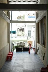 an empty balcony with a chair and a window at Lê Gia Homestay 2 in Hue