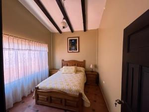 a bedroom with a bed and a window at MiniFinquita Ibarra in Ibarra