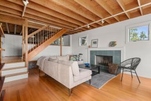 a living room with a couch and a fireplace at Vista Mare in Rockport