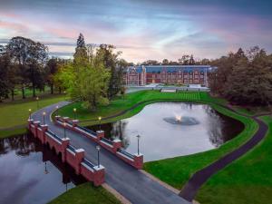 a large building with a pond in front of it at Fairmont Windsor Park in Windsor