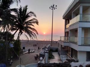 a view of a beach with a building and a sunset at holiday homes in Murud