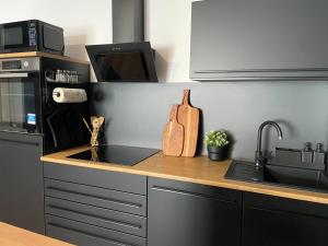 a kitchen with a counter with a sink and a microwave at Demhouse in Gössenheim +14 photos