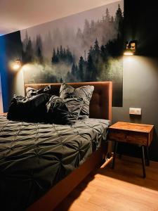 a bedroom with a bed with a painting on the wall at Demhouse in Gössenheim